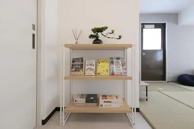 a book shelf with books on it in a room at Good access to Shinjuku! Japandi Style Room in Nakano, Tokyo - Podhouse Nakano in Tokyo