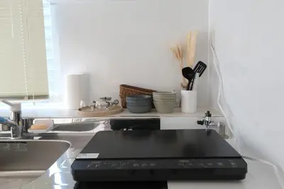 a kitchen with a sink and a laptop on a counter at Good access to Shinjuku! Japandi Style Room in Nakano, Tokyo - Podhouse Nakano in Tokyo