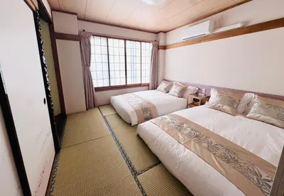 a room with two beds and a window at Private Room near Iriya in Tokyo