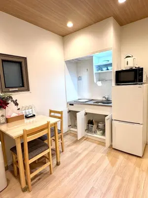 a kitchen and dining room with a table and a refrigerator at Private Room near Iriya in Tokyo