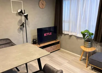 a living room with a television with the words netflix at Opening SALE! Stylish Room in Meguro Near Shibuya! in Tokyo