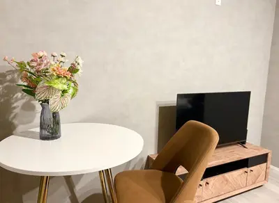 a vase of flowers on a table next to a tv at Opening SALE! Stylish Room in Meguro Near Shibuya! in Tokyo