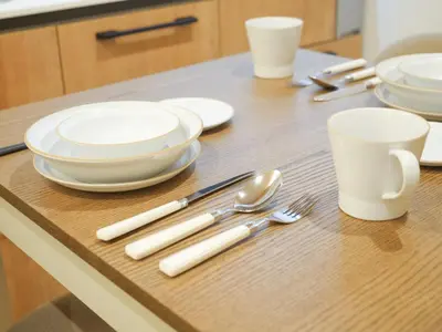 a table with white plates and utensils on it at MSTAY\u6771\u5411\u5cf6one in Tokyo