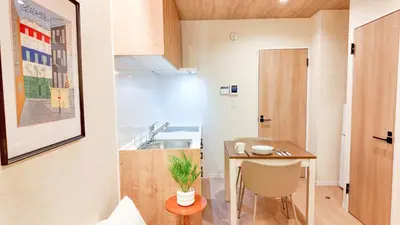 a small apartment with a small table and a kitchen at MSTAY\u6771\u5411\u5cf6one in Tokyo