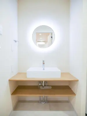 a bathroom with a white sink and a mirror at MSTAY\u6771\u5411\u5cf6one in Tokyo