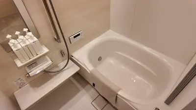 a white bathroom with a sink and a shower at MSTAY\u6771\u5411\u5cf6one in Tokyo