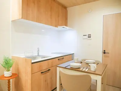 a kitchen with a sink and a table with chairs at MSTAY\u6771\u5411\u5cf6one in Tokyo