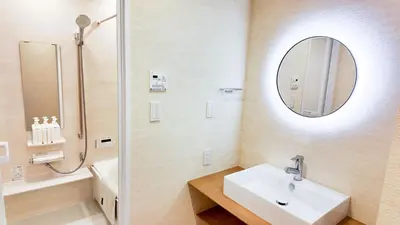 a white bathroom with a sink and a mirror at MSTAY\u6771\u5411\u5cf6one in Tokyo