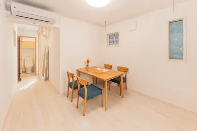 a dining room with a wooden table and chairs at Newly Built 4-Bedroom House in Shopping Street, 8-Min Walk from Akabane Station in Tokyo