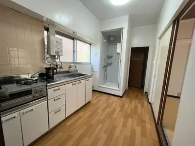 a kitchen with white cabinets and a wooden floor at Core of Tokyo, 30 mins from Shinjuku & Ueno, LARGE in Tokyo