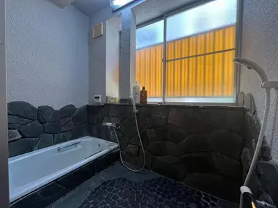 a bathroom with a bath tub and a window at Core of Tokyo, 30 mins from Shinjuku & Ueno, LARGE in Tokyo