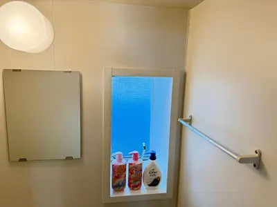 a bathroom with a mirror and two bottles of condiments at Shinjuku Area 41 Shinjuku Apartment in Tokyo