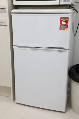 a white refrigerator with a microwave on top of it at Comore Villa 2F in Tokyo