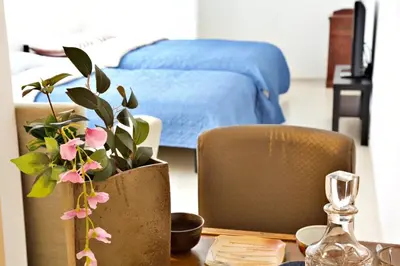 a bedroom with a bed and a wooden table with a table sidx sidx at Comore Villa 2F in Tokyo