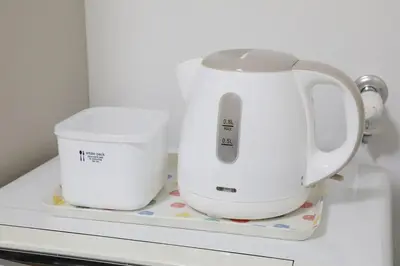 two white appliances sitting on top of a refrigerator at Comore Villa 2F in Tokyo