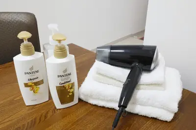 two towels and a blow dryer on a table at Comore Villa 2F in Tokyo