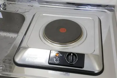 a stove top with a cd on top of it at Comore Villa 2F in Tokyo