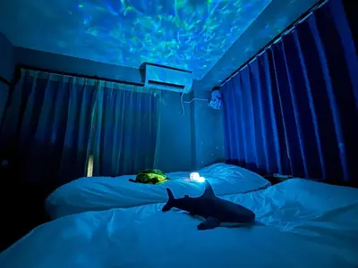 a bedroom with two beds with a shark on them at Direct to Narita 9min walk from Kinshicho St Within walking distance of Asakusa and Skytree 50min bus ride to Disneyland 3min walk from the mall in Tokyo