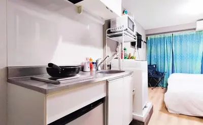a kitchen with a sink and a bed in a room at Direct to Narita 9min walk from Kinshicho St Within walking distance of Asakusa and Skytree 50min bus ride to Disneyland 3min walk from the mall in Tokyo