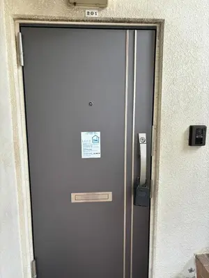 a metal door with a sign on it next to a building at Direct to Narita 9min walk from Kinshicho St Within walking distance of Asakusa and Skytree 50min bus ride to Disneyland 3min walk from the mall in Tokyo