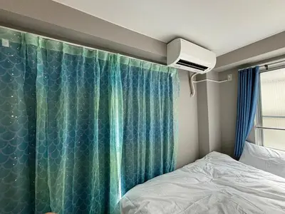 a bedroom with a bed and a shower curtain at Direct to Narita 9min walk from Kinshicho St Within walking distance of Asakusa and Skytree 50min bus ride to Disneyland 3min walk from the mall in Tokyo