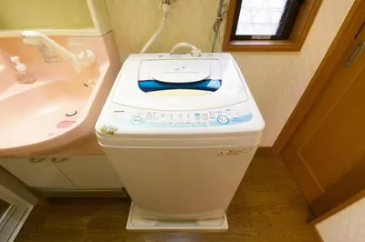 a small bathroom with a toilet and a sink at Peace House in Tokyo