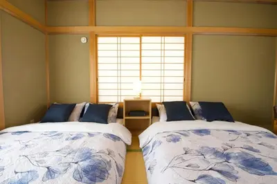 two beds sitting next to each other in a room at Peace House in Tokyo
