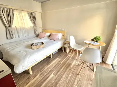 a bedroom with a bed and a table and chairs at ShinjukuCityStay 502 in Tokyo