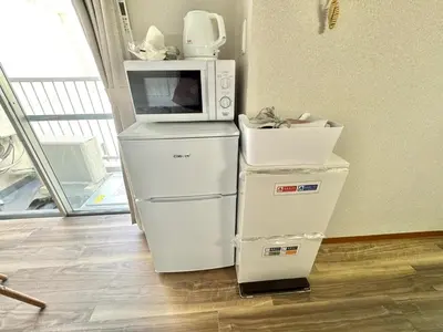 a microwave oven sitting on top of a refrigerator at ShinjukuCityStay 502 in Tokyo