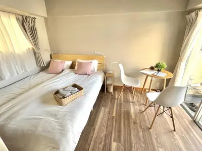 a bedroom with a bed and a table and chairs at ShinjukuCityStay 502 in Tokyo