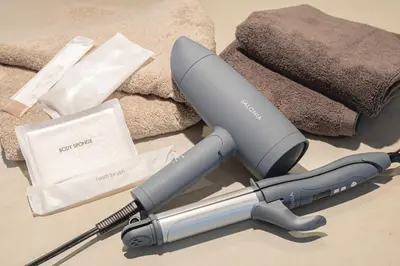 a electric hair dryer sitting next to a pile of towels at 200 m2 Modern Japanese style private 6LDK House in Tokyo
