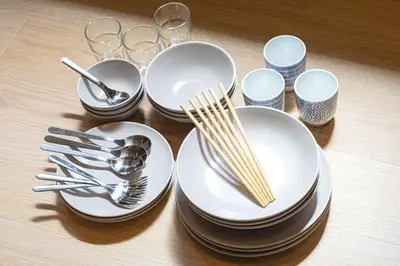 a table with white plates and forks and glasses at 200 m2 Modern Japanese style private 6LDK House in Tokyo