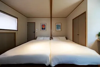 a large white bed in a room with a window at 200 m2 Modern Japanese style private 6LDK House in Tokyo