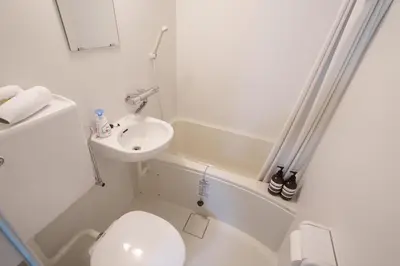 a white bathroom with a toilet and a sink at 3min walk to Asagaya Sta, Cozy Private Studio Direct access 8min to Shinjuku, 30min to Akihabara and Asakusa in Tokyo