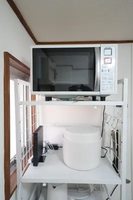 a microwave sitting on top of a white shelf at 3min walk to Asagaya Sta, Cozy Private Studio Direct access 8min to Shinjuku, 30min to Akihabara and Asakusa in Tokyo