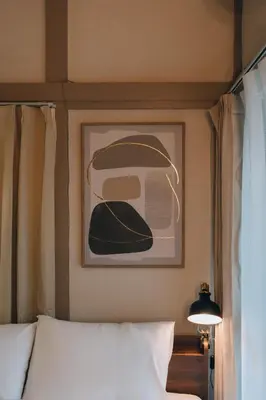 a bedroom with a picture of a hat on the wall at Tokyo Nest Ohana in Tokyo