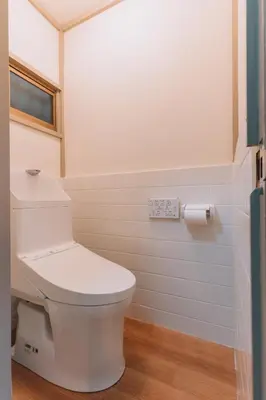 a bathroom with a white toilet and a window at Tokyo Nest Ohana in Tokyo