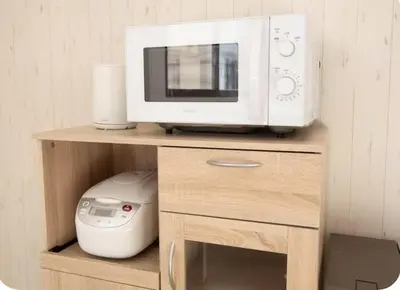 a microwave oven sitting on top of a wooden shelf at Opening in December Riverside stay to Akihabara Shinjuku in Tokyo