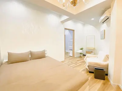 a bedroom with a large bed and a couch at Opening in December Riverside stay to Akihabara Shinjuku in Tokyo