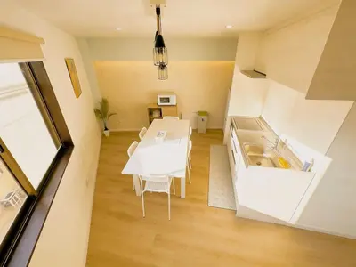 a kitchen and dining room with a white table at Opening in December Riverside stay to Akihabara Shinjuku in Tokyo