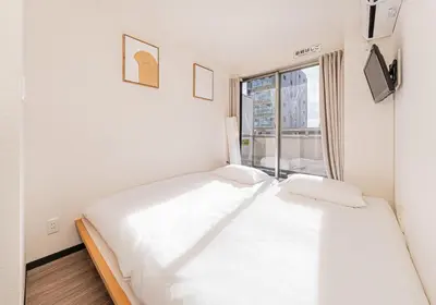 a white bed in a room with a window at Louis stage showamachi in Tokyo