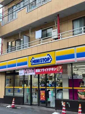 a building with a food store on the street at Louis stage showamachi in Tokyo