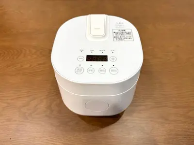 a white electronic device sitting on a wooden table at 301, 6 min walk to subway stn, Tokyo Univ, Tokyo Tower, Tokyo-Dome direct by subway in Tokyo