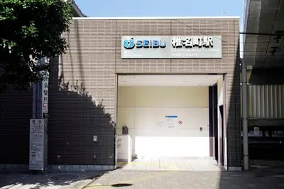 a building with a garage with a sign on it at Group Friendly - Prime 3BR - Great Location & Rooftop in Tokyo