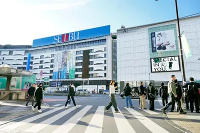 a group of people crossing a street in front of a building at Group Friendly - Prime 3BR - Great Location & Rooftop in Tokyo
