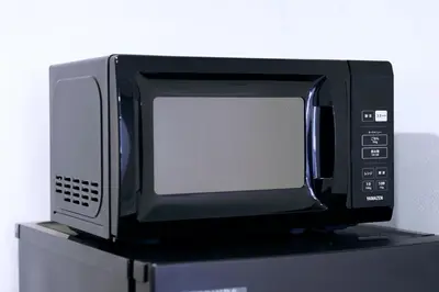 a microwave oven sitting on top of a shelf at Group Friendly - Prime 3BR - Great Location & Rooftop in Tokyo