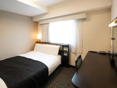 a hotel room with a bed and a window at APA Hotel Ueno Ekikita in Tokyo