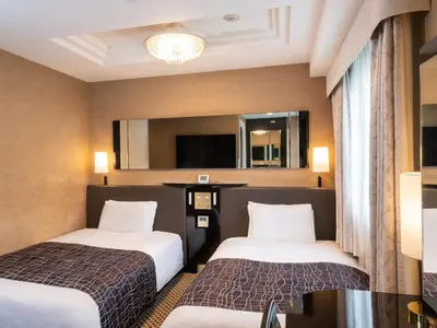 a hotel room with two beds and a mirror at APA Hotel Ueno Ekikita in Tokyo
