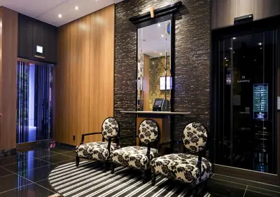 a lobby with two chairs and a desk in a building at APA Hotel Ueno Ekikita in Tokyo