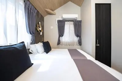a bedroom with a bed and a window at Bijou Suites Zephyr in Tokyo